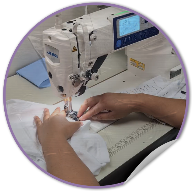 Person operating a Juki sewing machine with fabric and a digital display.