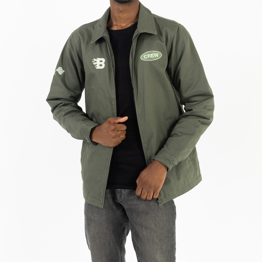 Person wearing an embroidered green jacket with logos on a white background ideal for employee uniform and company merch. This image shows cool swag.