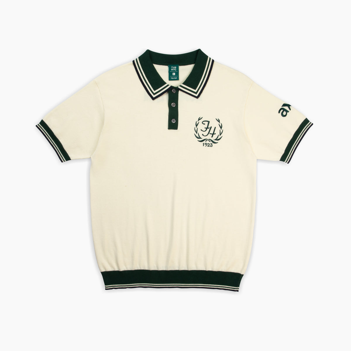 Custom Embroidery Services, Branded Knit Polo, High-Density Logo Stitching, Premium Apparel Branding, TVP NYC Merch Solutions. An off-white knit polo shirt with dark green trim featuring a detailed embroidered "Forrest Hills 1923" crest on the chest and text on the sleeve.