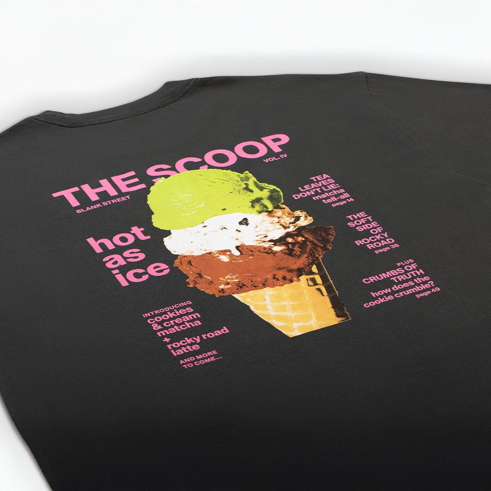 Professional Screen Printing, Custom Graphic Tees, High-Impact Brand Swag, Retail-Quality Merch, TVP NYC Print Services. A close-up of the back of a black t-shirt featuring a large, colorful graphic of an ice cream cone with pink and white text titled "THE SCOOP".