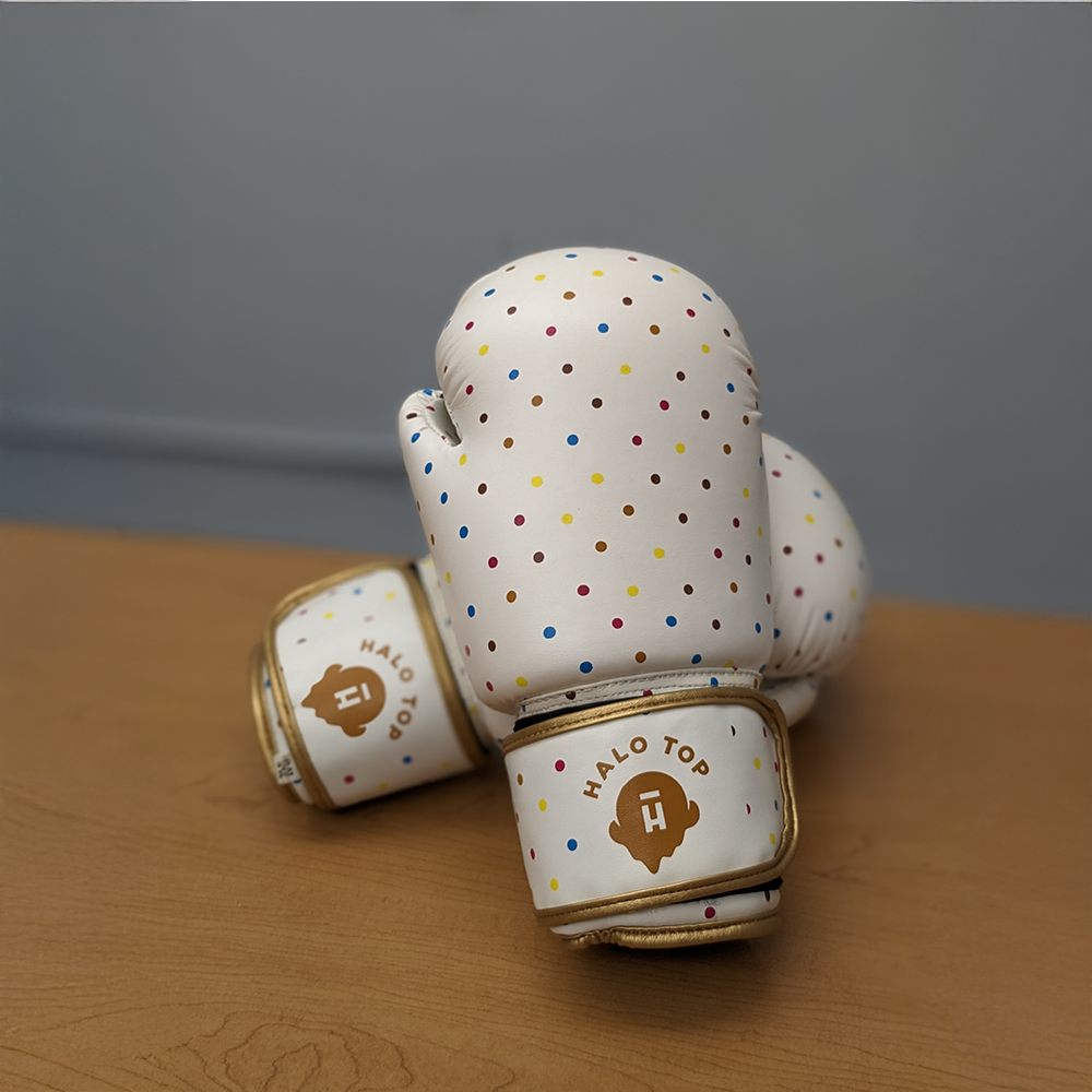 A unique piece of specialty swag featuring white boxing gloves covered in a colorful polka-dot pattern with the gold "Halo Top" logo on the wrist strap.
