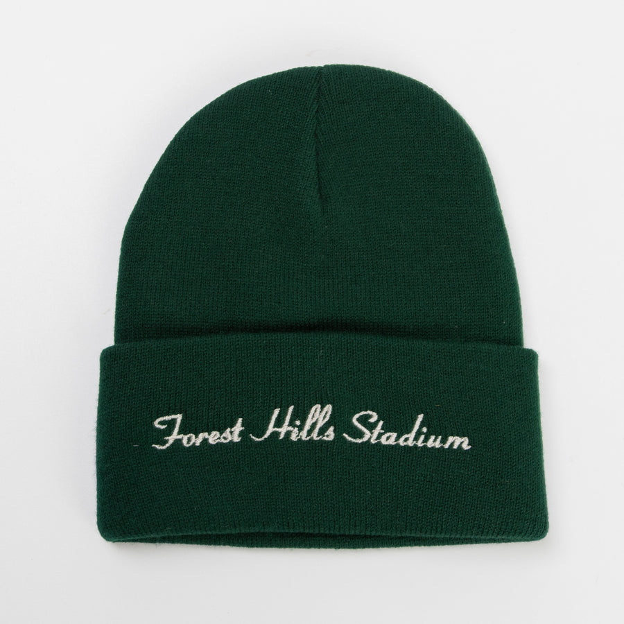 Professional Embroidery Services, Custom Branded Hats, 3D Puff Embroidery, Retail-Quality Swag, TVP NYC Merch Solutions. A deep green knit beanie featuring white cursive "Forest Hills Stadium" embroidery, showcasing precision needlework on a textured fabric.
