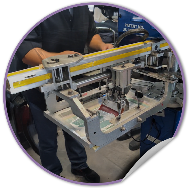 Person operating a screen printing machine with a focus on the equipment